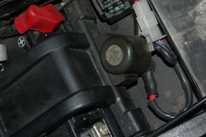 The starter solenoid sits under the seat next to the battery